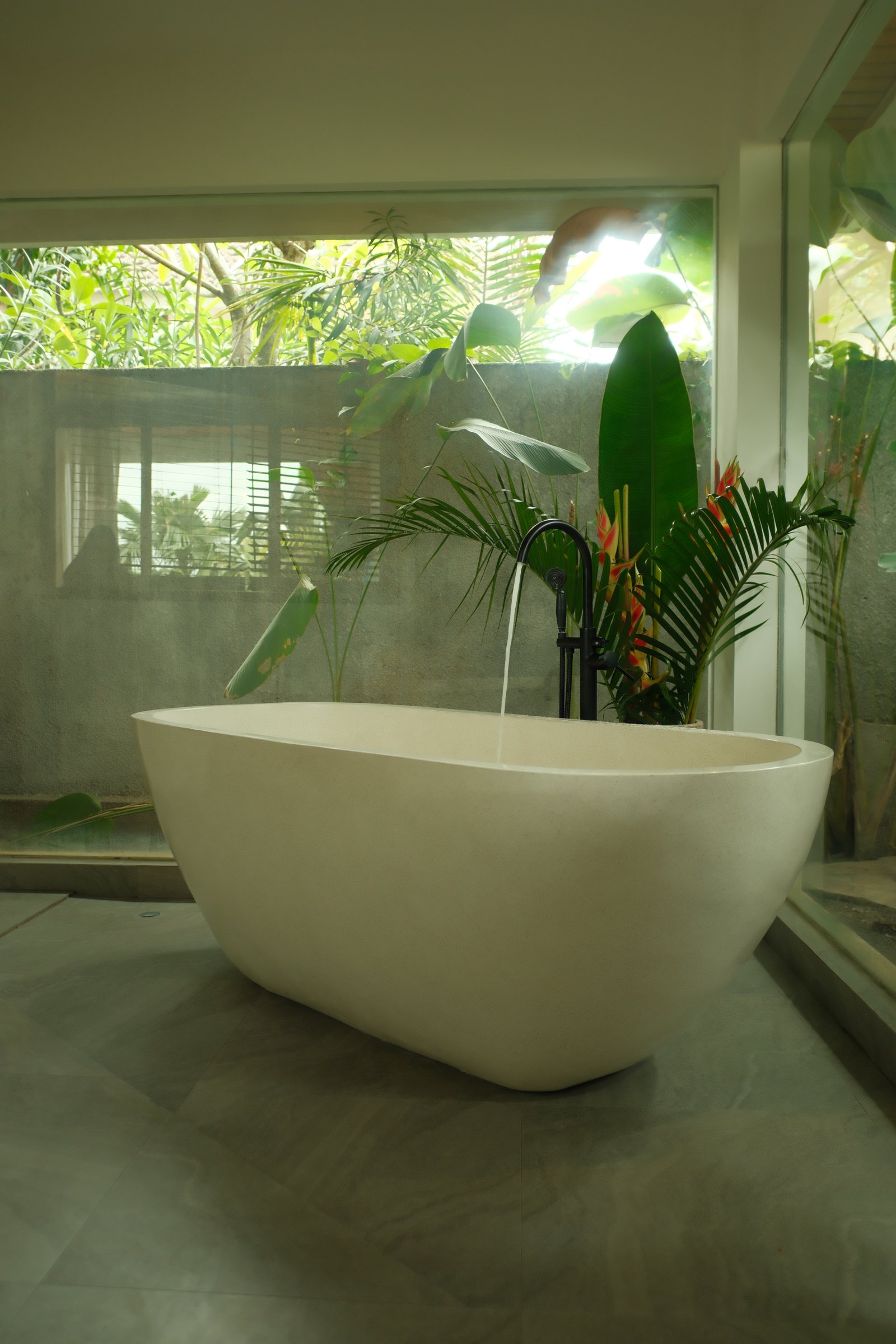 Contemporary living space with staircase, seating, and layered natural materials